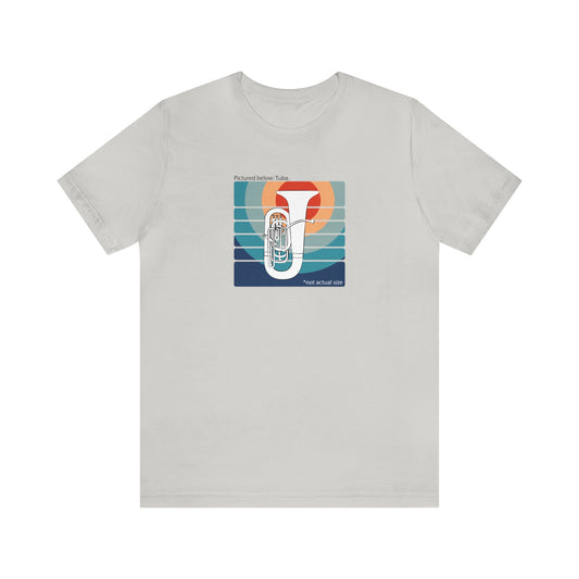 Graphic Music T-shirt with an image of a tuba on colorful background and the words "Pictured below: Tuba" and "Not Actual Size."  Cool gray shirt.