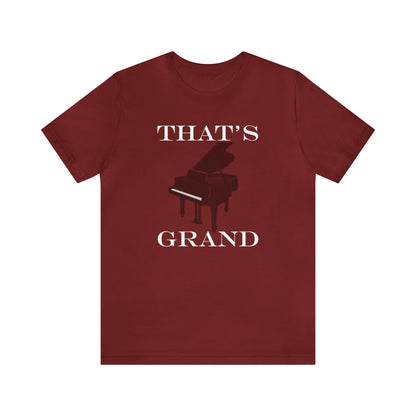 A graphic music pun t-shirt with an image of a grand piano and the words "That's Grand".  Red shirt.