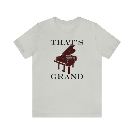 A graphic music pun t-shirt with an image of a grand piano and the words "That's Grand". Light grey shirt.