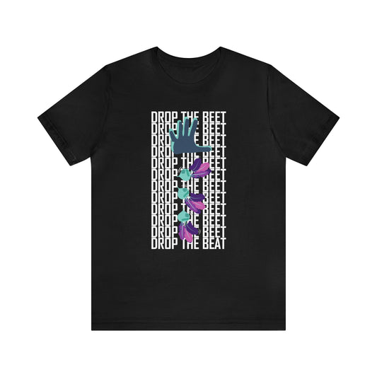 Music pun graphic tee.  Picture of a hand dropping a beet with the words "drop the beet" and "drop the beat" arrayed behind the graphic.  Black shirt.