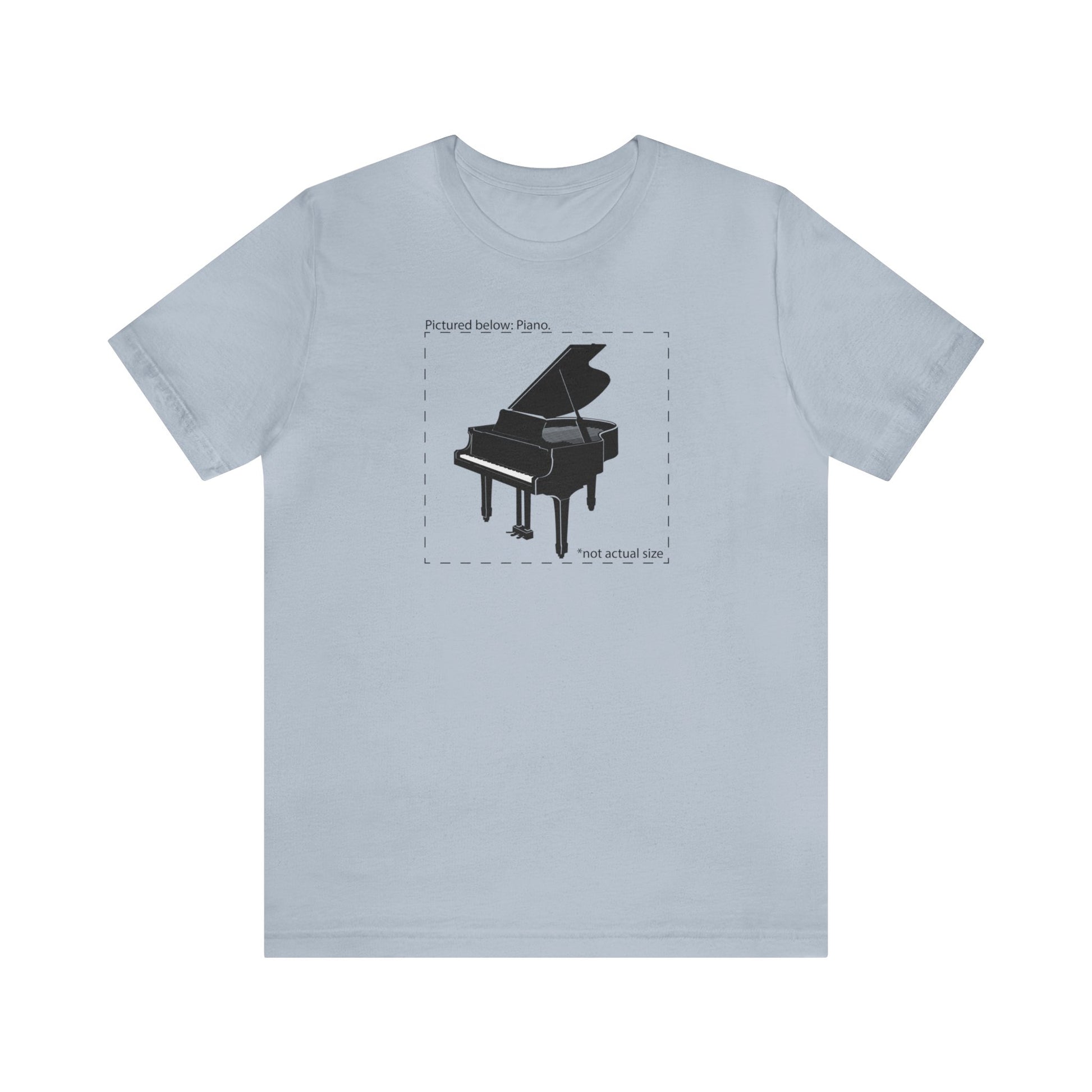 Graphic music t-shirt.  A grand piano and the words "Pictured Below: Piano" followed by the text "Not actual size."  Light blue shirt.